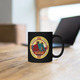 Black mug with New Mexico Road Trip logo sitting on table