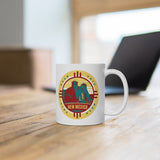 White mug with New Mexico Road Trip logo sitting on table