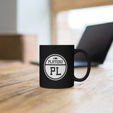 Black mug with Plateau logo sitting on a table