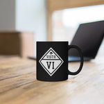 Black mug with Vista logo sitting on a table